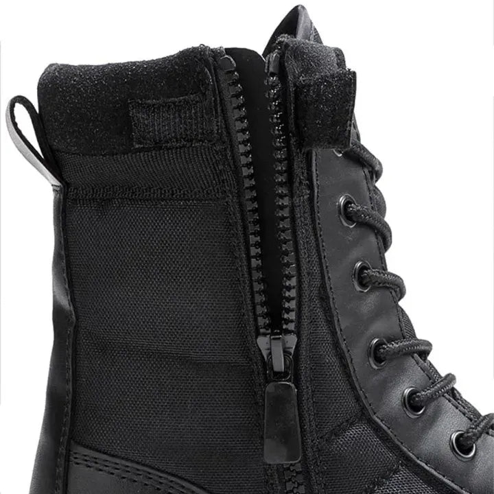 Close-up of a black lace-up ankle boot with a side zipper, black laces, metal eyelets, and a textured fabric collar on a white background.